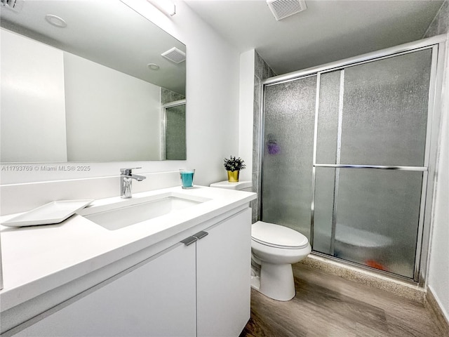 3731 N Country Club Dr Unit 2228, Aventura, FL 33180 - full bathroom featuring wood finished floors, a shower stall, vanity, and toilet