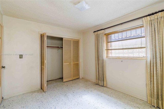unfurnished bedroom featuring a closet and a textured ceiling