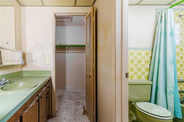 bathroom with vanity, toilet, a closet, and curtained shower