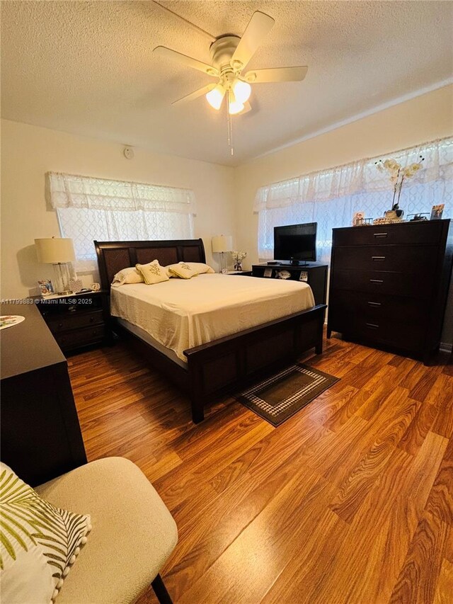 940 Hillcrest Ct Unit 112, Hollywood, FL 33021 - bedroom with wood finished floors, a textured ceiling, and ceiling fan