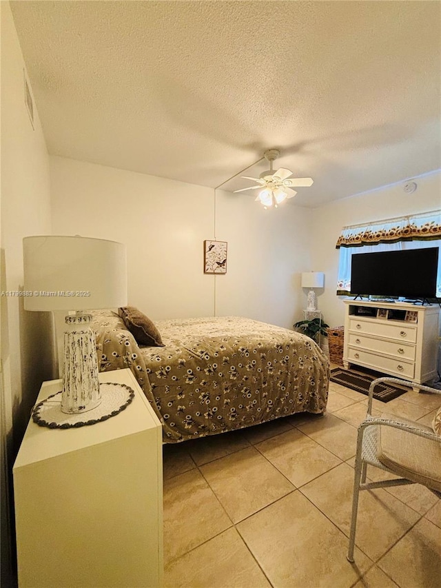 940 Hillcrest Ct Unit 112, Hollywood, FL 33021 - bedroom featuring light tile patterned floors, a textured ceiling, and a ceiling fan
