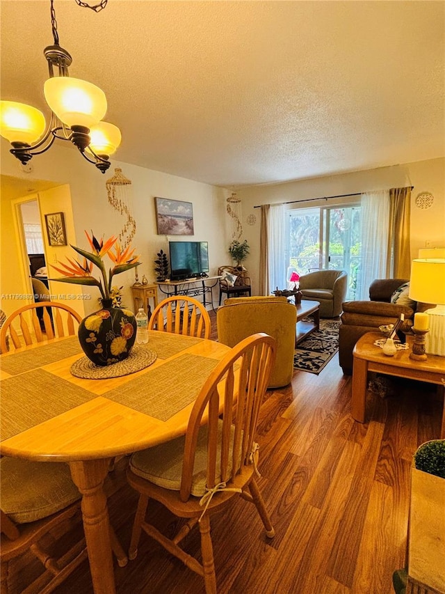 940 Hillcrest Ct Unit 112, Hollywood, FL 33021 - dining area with light wood-style flooring, a textured ceiling, and a chandelier