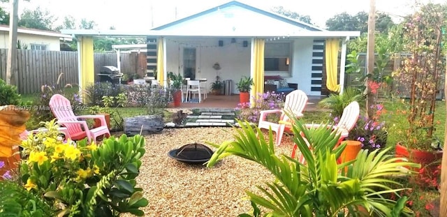 1291 NE 146th St, Miami, FL 33161 - rear view of house featuring a fire pit, a patio area, fence, and stucco siding
