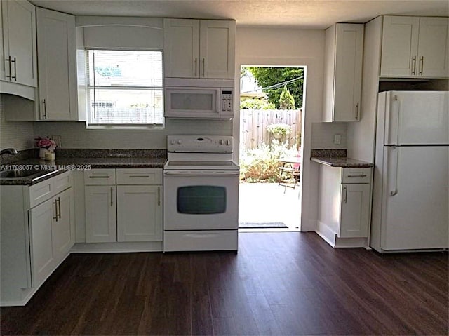 1291 NE 146th St, Miami, FL 33161 - kitchen featuring white appliances, a sink, dark wood-style flooring, backsplash, and white cabinetry