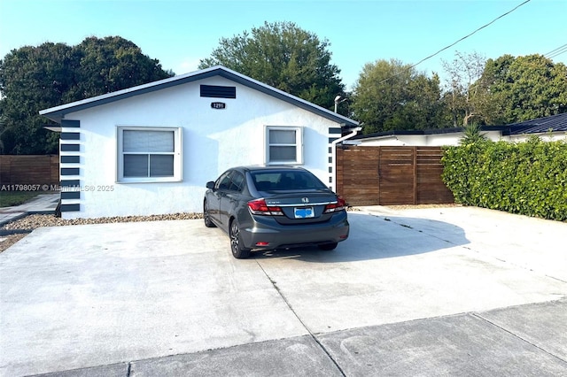 1291 NE 146th St, Miami, FL 33161 - view of front facade with fence and stucco siding