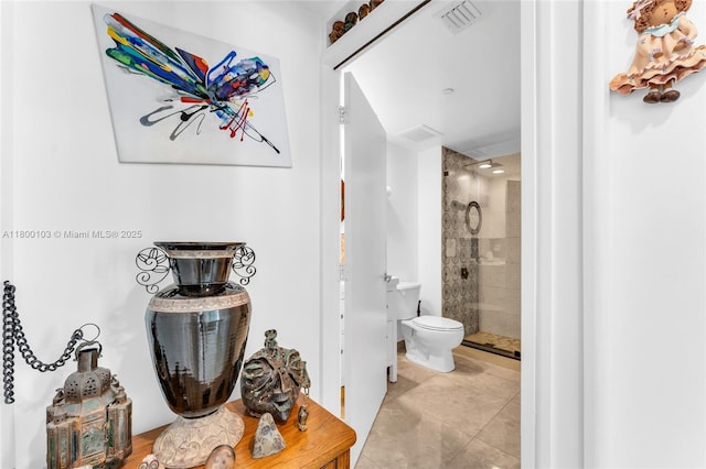 full bathroom with a shower stall, toilet, and tile patterned floors