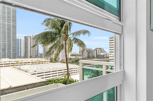 balcony with a skyline view and a water view