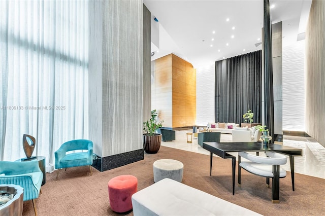 common area with a towering ceiling and recessed lighting