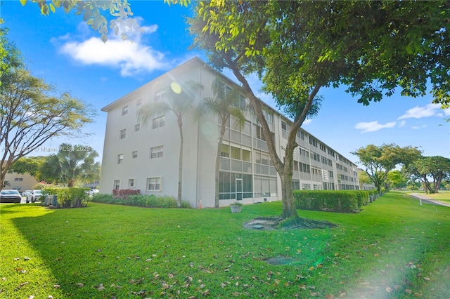 300 SW 134th Way Unit 413E, Pembroke Pines, FL 33027 - view of home's exterior with stucco siding and a lawn