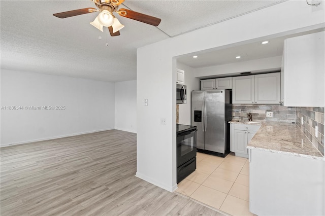 300 SW 134th Way Unit 413E, Pembroke Pines, FL 33027 - kitchen featuring stainless steel appliances, backsplash, a textured ceiling, light wood-type flooring, and a ceiling fan