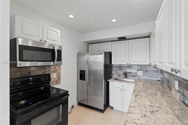 300 SW 134th Way Unit 413E, Pembroke Pines, FL 33027 - kitchen featuring stainless steel appliances, a sink, white cabinetry, decorative backsplash, and recessed lighting