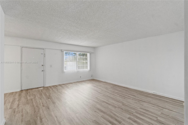 300 SW 134th Way Unit 413E, Pembroke Pines, FL 33027 - spare room featuring wood finished floors, a textured ceiling, and baseboards