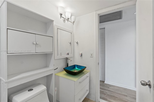 300 SW 134th Way Unit 413E, Pembroke Pines, FL 33027 - bathroom with wood finished floors, toilet, vanity, and baseboards