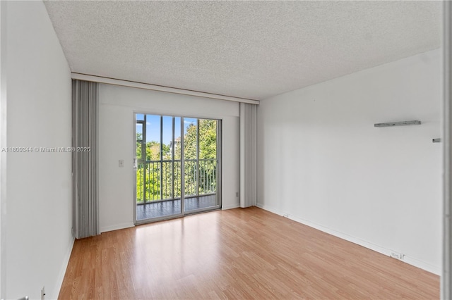 300 SW 134th Way Unit 413E, Pembroke Pines, FL 33027 - empty room featuring wood finished floors, a textured ceiling, and baseboards