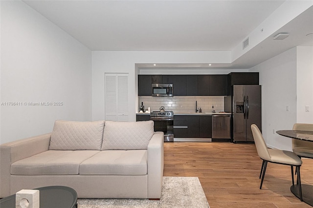 398 NE 5th St Unit 2415, Miami, FL 33132 - living area featuring light wood finished floors