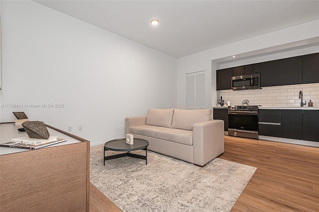 398 NE 5th St Unit 2415, Miami, FL 33132 - living room featuring light wood finished floors and recessed lighting