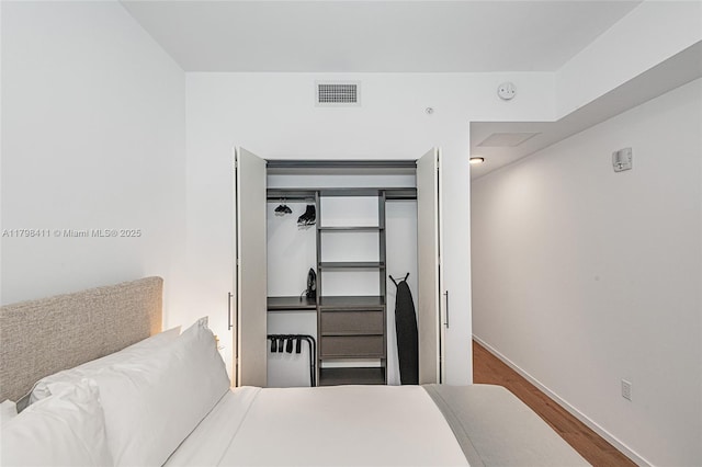 398 NE 5th St Unit 2415, Miami, FL 33132 - bedroom with wood finished floors, baseboards, and a closet