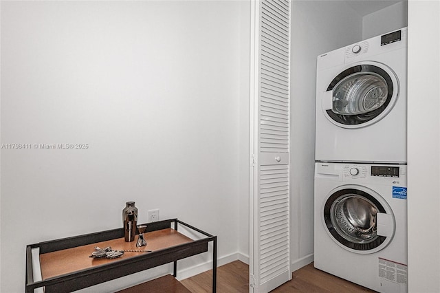 398 NE 5th St Unit 2415, Miami, FL 33132 - laundry area with estacked washer and dryer, wood finished floors, and baseboards