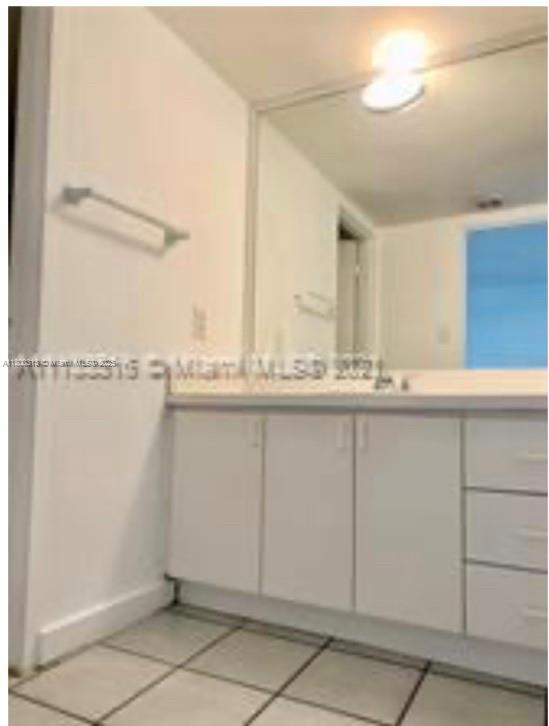 9225 Collins Ave Unit 307, Surfside, FL 33154 - bathroom featuring tile patterned floors, vanity, and baseboards