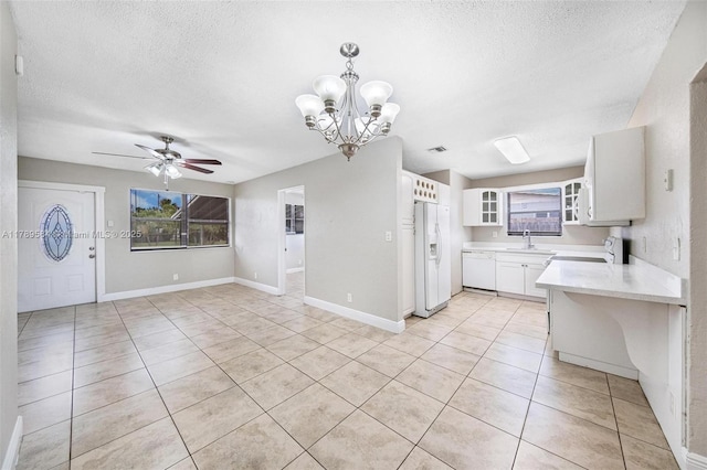4138 NW 12th Ter, Oakland Park, FL 33309 - kitchen with white appliances, a sink, light countertops, light tile patterned floors, and a textured ceiling