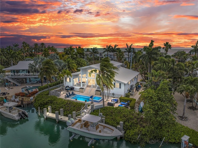 1220 Coury Dr, Key Colony, FL 33051 - aerial view at dusk of a water view and view of pool area