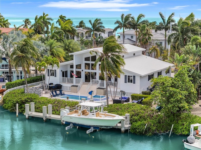 1220 Coury Dr, Key Colony, FL 33051 - back of property featuring boat lift, an outdoor pool, a patio area, and a deck with water view