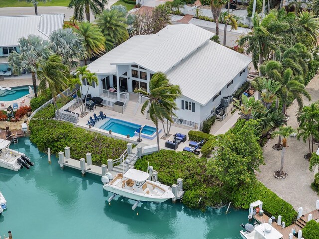 1220 Coury Dr, Key Colony, FL 33051 - aerial view of property and surrounding area featuring a pool and a nearby body of water