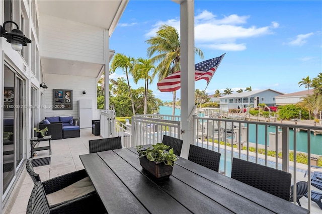 1220 Coury Dr, Key Colony, FL 33051 - balcony with an outdoor living space, outdoor dining area, and a water view