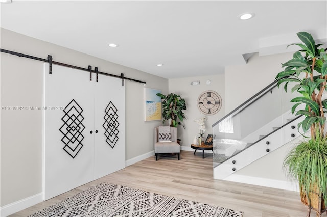1220 Coury Dr, Key Colony, FL 33051 - entryway with a barn door, wood finished floors, stairs, baseboards, and recessed lighting
