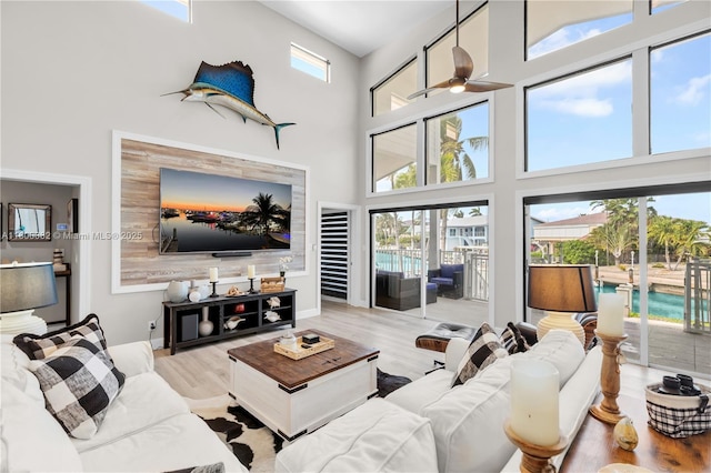 1220 Coury Dr, Key Colony, FL 33051 - living area with a towering ceiling, wood finished floors, and a ceiling fan