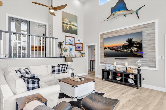 1220 Coury Dr, Key Colony, FL 33051 - living area featuring ceiling fan, wood finished floors, a towering ceiling, and baseboards