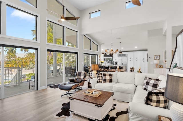 1220 Coury Dr, Key Colony, FL 33051 - living room with a towering ceiling, ceiling fan, wood finished floors, and a chandelier