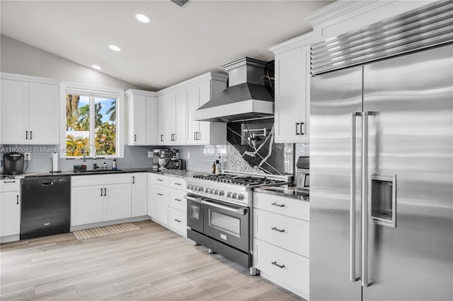 1220 Coury Dr, Key Colony, FL 33051 - kitchen with high quality appliances, wall chimney range hood, lofted ceiling, backsplash, and a sink