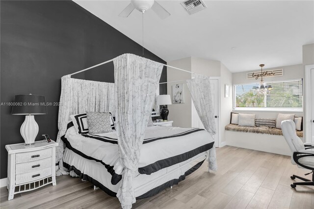 1220 Coury Dr, Key Colony, FL 33051 - bedroom featuring wood finished floors, vaulted ceiling, a chandelier, baseboards, and ceiling fan