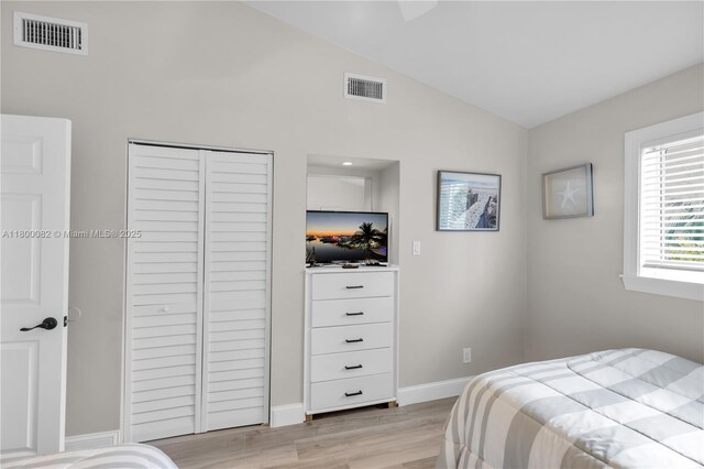 1220 Coury Dr, Key Colony, FL 33051 - bedroom with light wood-type flooring, a closet, baseboards, and high vaulted ceiling
