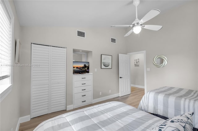 1220 Coury Dr, Key Colony, FL 33051 - bedroom with light wood-style flooring, a closet, baseboards, high vaulted ceiling, and a ceiling fan