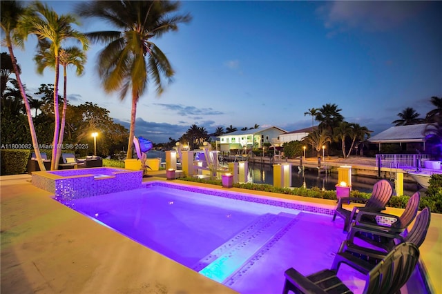 1220 Coury Dr, Key Colony, FL 33051 - view of pool featuring a water view, a pool with connected hot tub, and a patio area