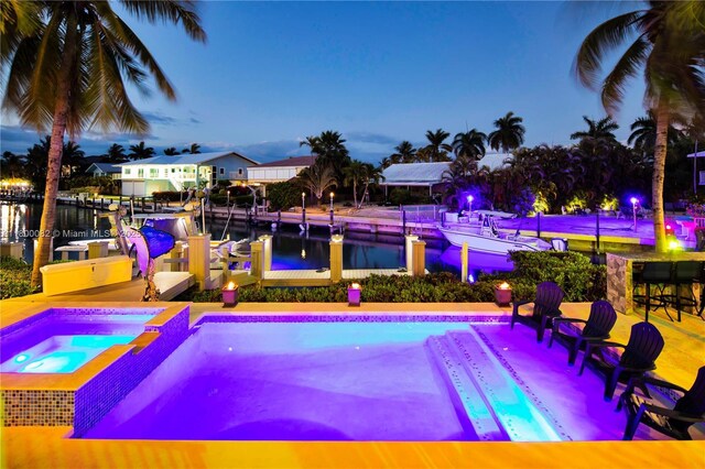 1220 Coury Dr, Key Colony, FL 33051 - view of pool featuring an in-ground hot tub, boat lift, a dock, and a water view