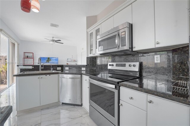 11324 NW 74th Ter, Doral, FL 33178 - kitchen featuring appliances with stainless steel finishes, light marble finish flooring, a peninsula, decorative backsplash, and a sink