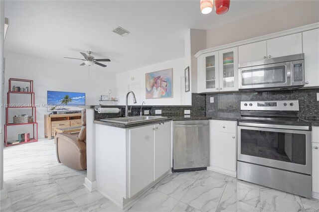 11324 NW 74th Ter, Doral, FL 33178 - kitchen with stainless steel appliances, a peninsula, a ceiling fan, and light marble finish flooring
