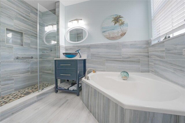 11324 NW 74th Ter, Doral, FL 33178 - bathroom featuring a stall shower, vanity, a garden tub, and tile walls