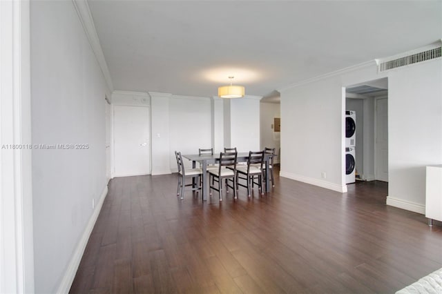 6770 Indian Creek Dr Unit 6O, Miami Beach, FL 33141 - dining space with stacked washing machine and dryer, dark wood-type flooring, ornamental molding, and baseboards