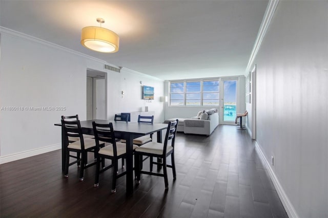 6770 Indian Creek Dr Unit 6O, Miami Beach, FL 33141 - dining area featuring crown molding, dark wood-style floors, and baseboards