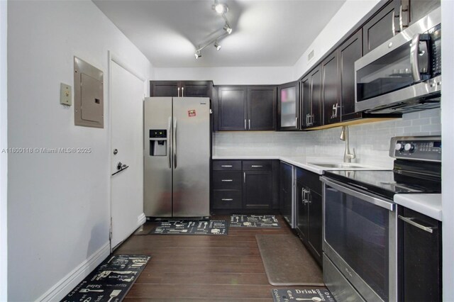 6770 Indian Creek Dr Unit 6O, Miami Beach, FL 33141 - kitchen with stainless steel appliances, electric panel, a sink, dark wood-style floors, and tasteful backsplash