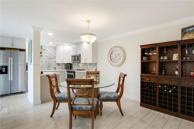 825 Center St Unit 24A, Jupiter, FL 33458 - dining area featuring light wood finished floors, ornamental molding, and baseboards
