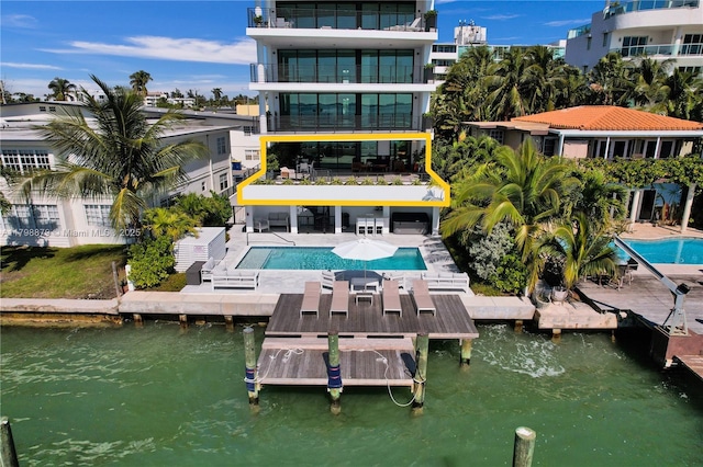 1930 Bay Dr Unit Ph-1, Miami Beach, FL 33141 - rear view of house with a water view, a community pool, and a patio area