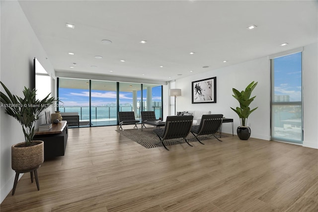 1930 Bay Dr Unit Ph-1, Miami Beach, FL 33141 - living area featuring expansive windows, wood finished floors, and recessed lighting