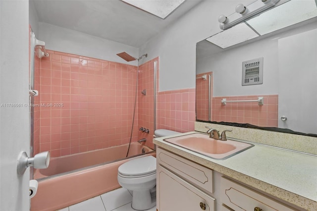 11930 NE 19th Dr Unit 15, North Miami, FL 33181 - bathroom featuring toilet, tile patterned flooring, bathing tub / shower combination, vanity, and tile walls