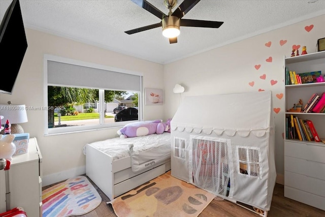 9831 SW 58th Ct, Cooper City, FL 33328 - bedroom with wood finished floors, a textured ceiling, a ceiling fan, and baseboards