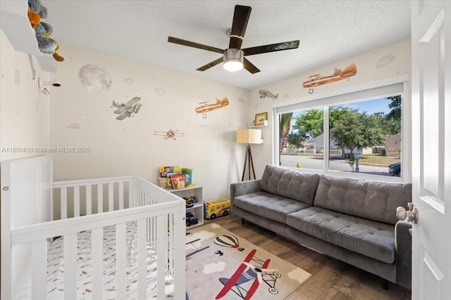 9831 SW 58th Ct, Cooper City, FL 33328 - bedroom featuring wood finished floors, a textured ceiling, and a ceiling fan